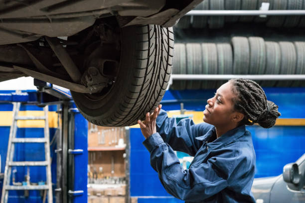 Auto mechanic inspecting a car tyre