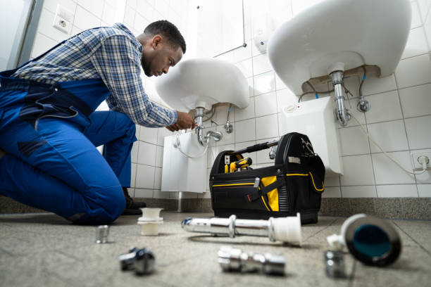 Plumber repairing a sink pipe